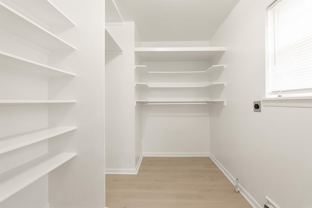 spacious closet with light wood-style flooring