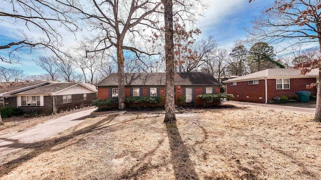 ranch-style house with driveway and brick siding