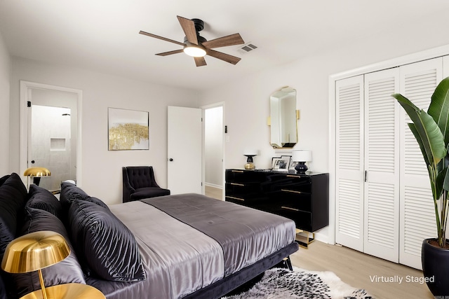 bedroom featuring light wood finished floors, a closet, and visible vents