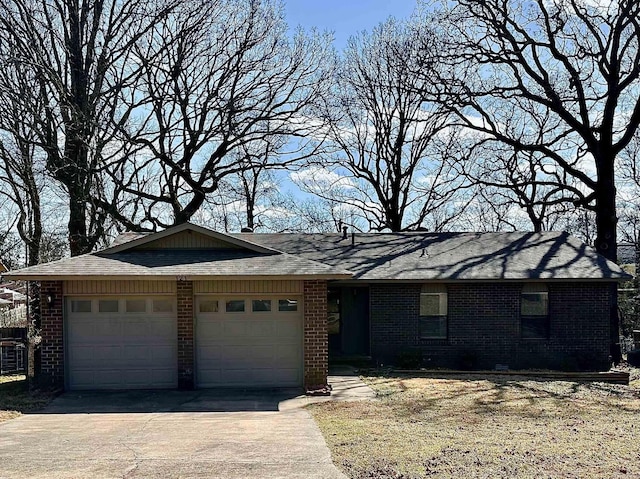 ranch-style house with concrete driveway, brick siding, and an attached garage