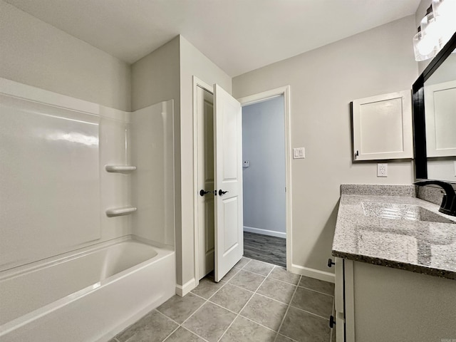 bathroom featuring baseboards, shower / washtub combination, vanity, and tile patterned floors