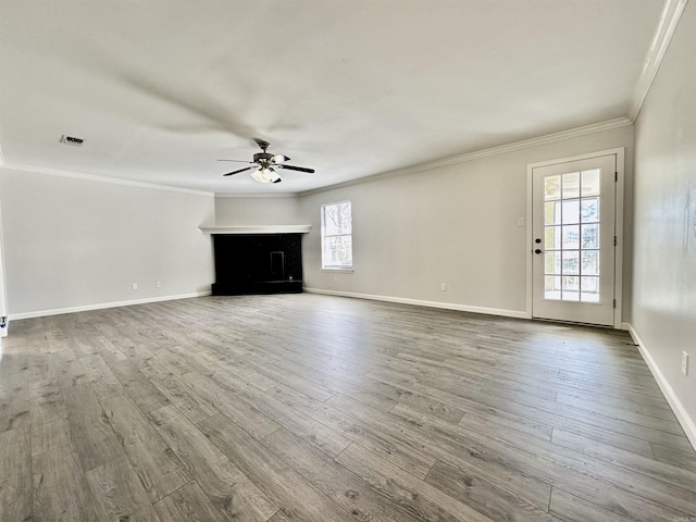 unfurnished living room with a fireplace, wood finished floors, and crown molding