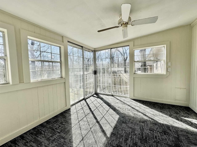 unfurnished sunroom featuring a ceiling fan