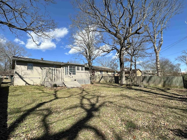 view of yard featuring fence and a wooden deck