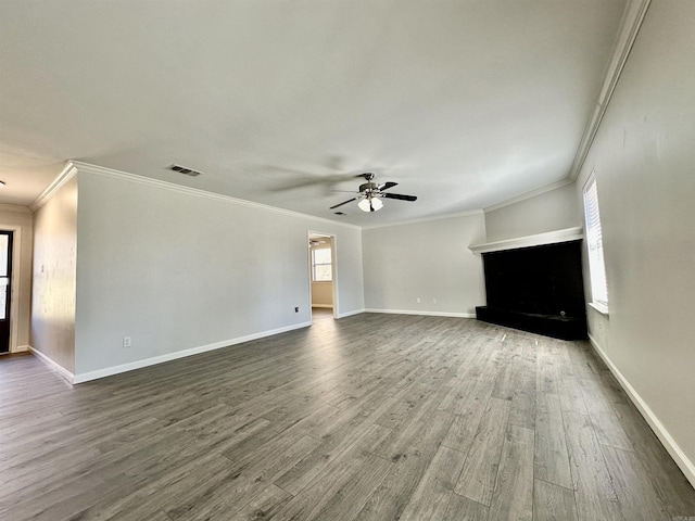 unfurnished living room with dark wood-style floors, visible vents, ceiling fan, and baseboards