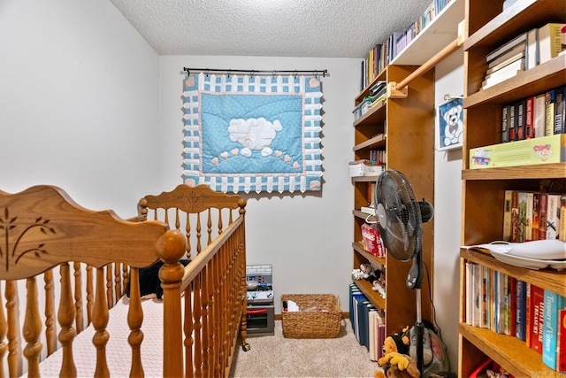 carpeted bedroom featuring a textured ceiling