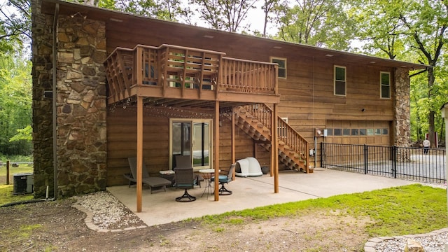 back of property with stairs, fence, a wooden deck, a patio area, and central AC