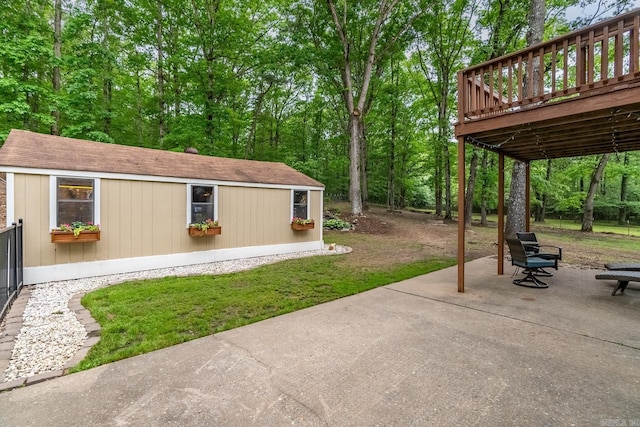 view of patio / terrace with an outbuilding and a wooden deck