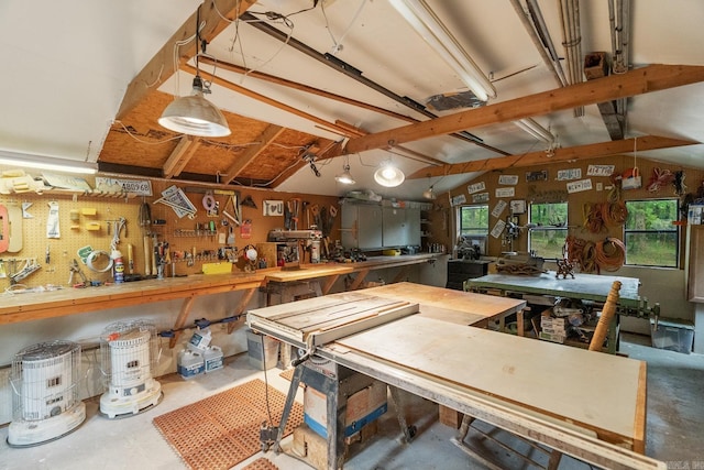 interior space featuring concrete flooring and lofted ceiling