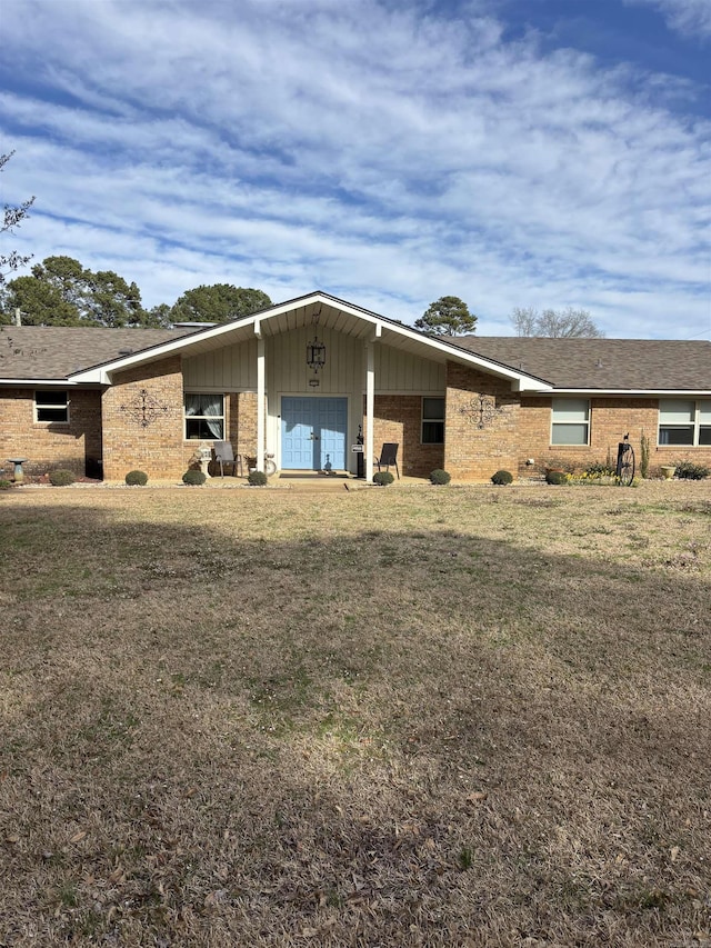 view of front of house with a front lawn and brick siding