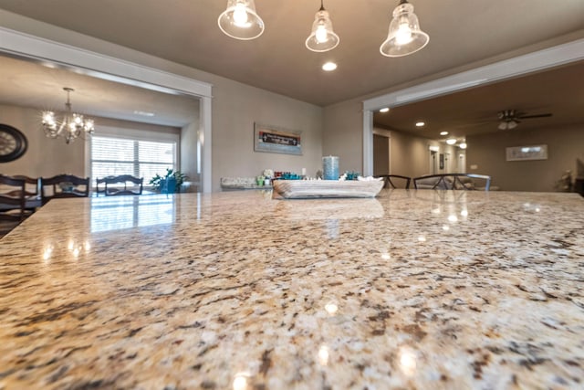 kitchen with a ceiling fan, recessed lighting, decorative light fixtures, and light stone countertops