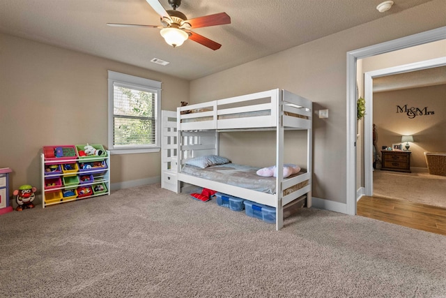 bedroom featuring carpet floors, visible vents, baseboards, and a ceiling fan