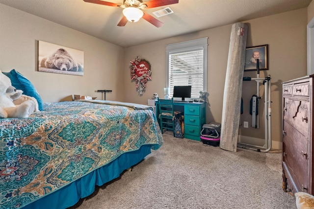 carpeted bedroom featuring ceiling fan and visible vents