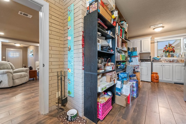 storage featuring visible vents and washer / dryer