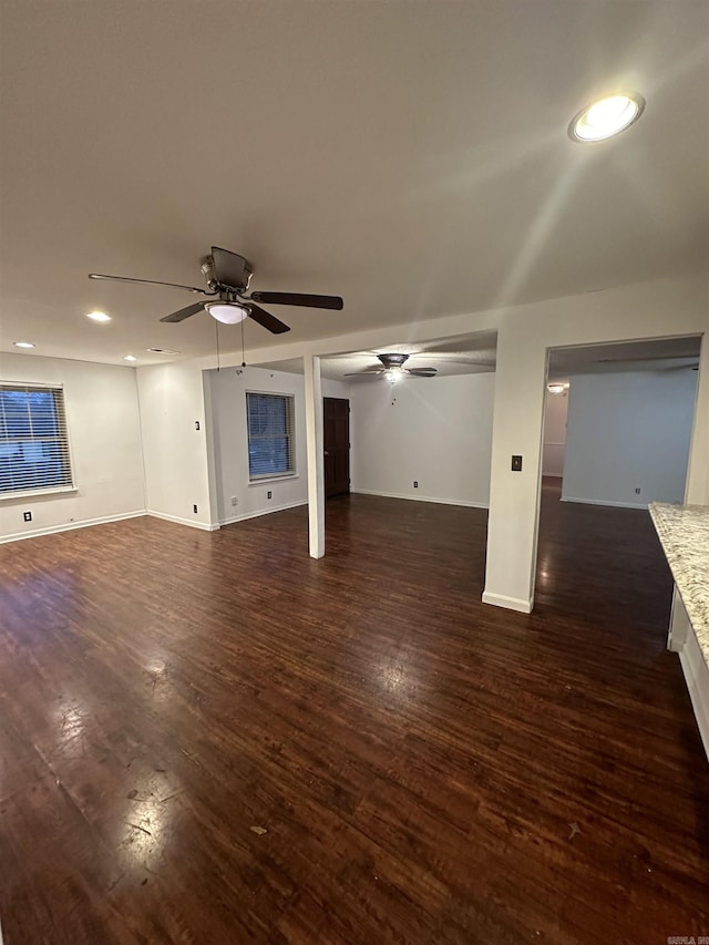 below grade area featuring a ceiling fan, recessed lighting, dark wood-style flooring, and baseboards