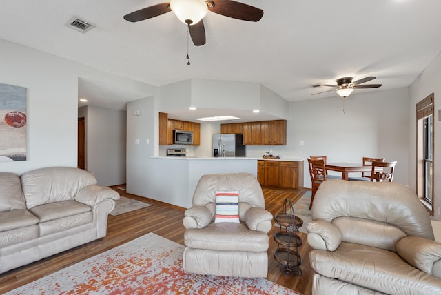 living room featuring recessed lighting, wood finished floors, visible vents, baseboards, and a ceiling fan