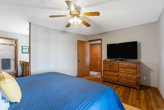 bedroom with ceiling fan, a textured ceiling, baseboards, and wood finished floors