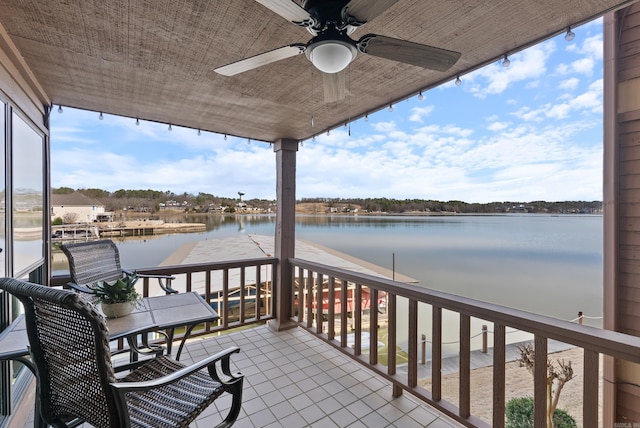 balcony with a water view and ceiling fan