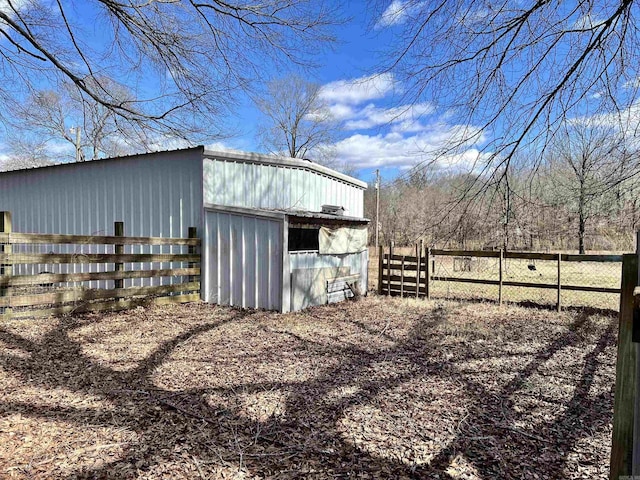 view of outbuilding with an outbuilding and fence