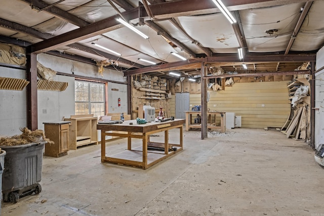 basement with a workshop area and baseboard heating