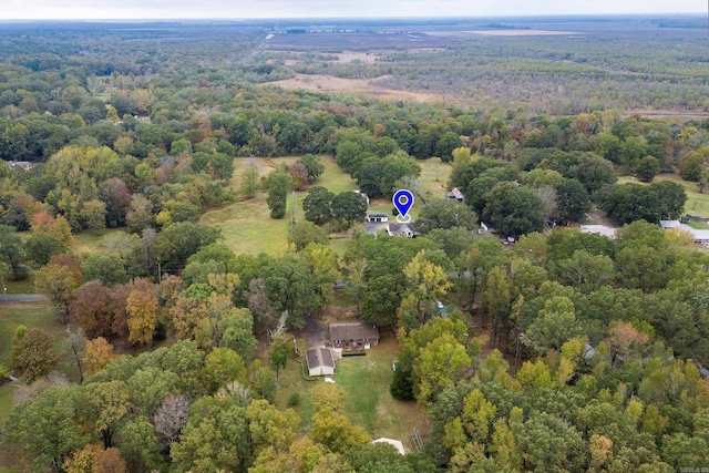 birds eye view of property with a view of trees