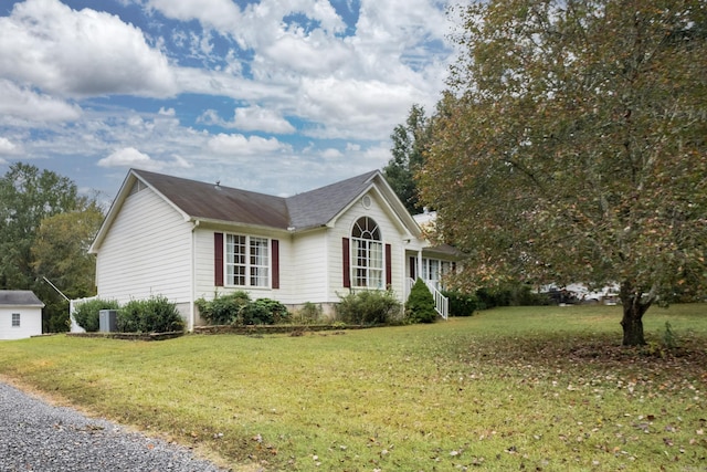 view of property exterior with a lawn and central AC unit