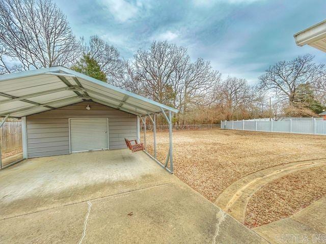 view of yard featuring a garage and fence