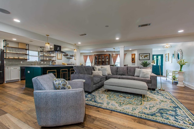 living room featuring baseboards, dark wood finished floors, visible vents, and recessed lighting