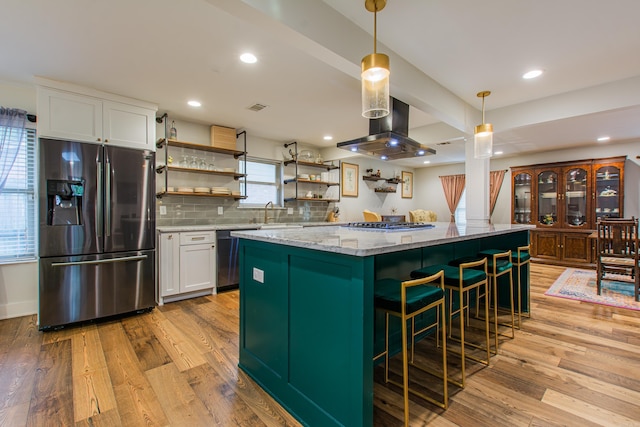 kitchen with light wood-style flooring, island range hood, stainless steel appliances, white cabinets, and open shelves