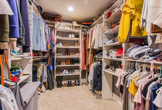 walk in closet featuring carpet flooring