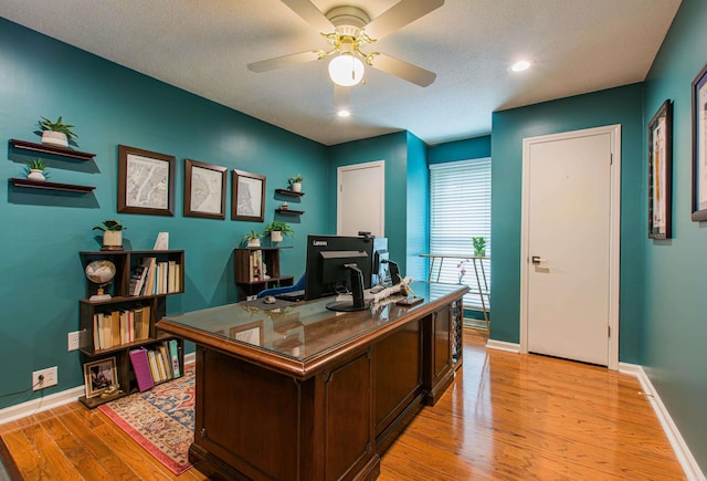 office space featuring light wood finished floors, baseboards, a ceiling fan, and recessed lighting