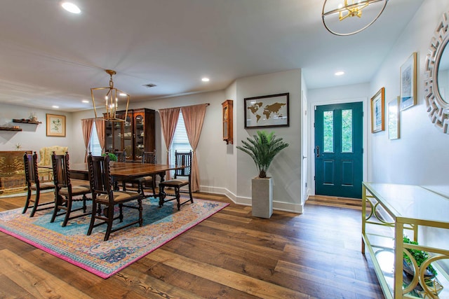 dining room featuring a chandelier, wood-type flooring, baseboards, and recessed lighting