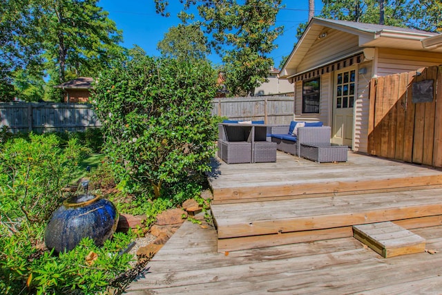 wooden terrace with a fenced backyard and an outdoor living space