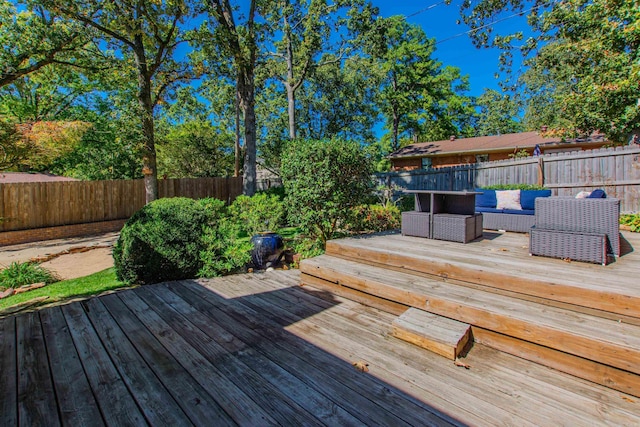 deck featuring a fenced backyard and an outdoor hangout area