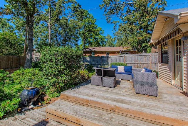 wooden terrace featuring a fenced backyard and outdoor lounge area