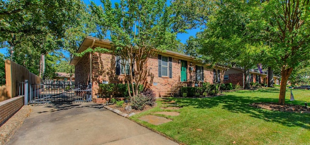 view of side of home featuring brick siding, fence, and a yard