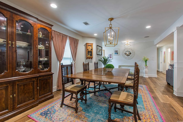 dining room featuring recessed lighting, wood finished floors, visible vents, and a notable chandelier