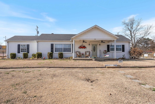 ranch-style house with ceiling fan and a porch