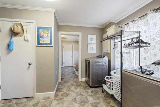 clothes washing area featuring washer / dryer, laundry area, ornamental molding, and baseboards