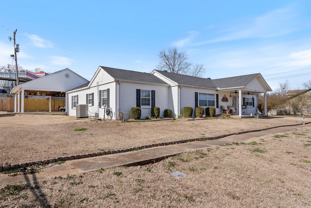 ranch-style house with covered porch, central AC unit, a ceiling fan, fence, and a carport