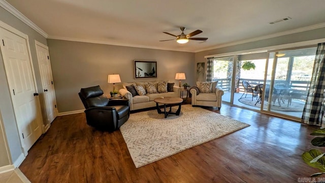 living area featuring dark wood-style floors, crown molding, visible vents, ceiling fan, and baseboards