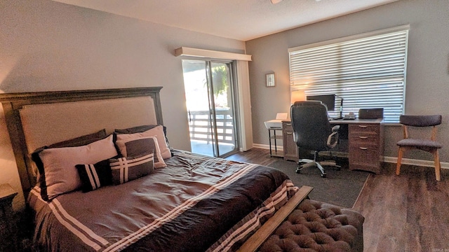 bedroom with access to outside, dark wood finished floors, and baseboards