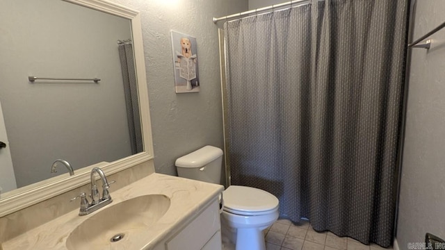 bathroom featuring curtained shower, vanity, toilet, and tile patterned floors