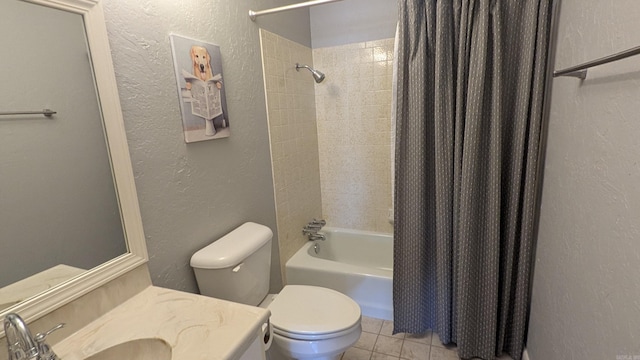 bathroom with shower / bath combination with curtain, a textured wall, vanity, and toilet