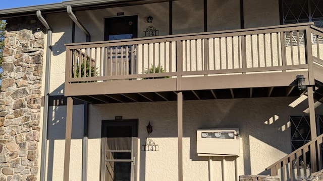 property entrance with stone siding and stucco siding