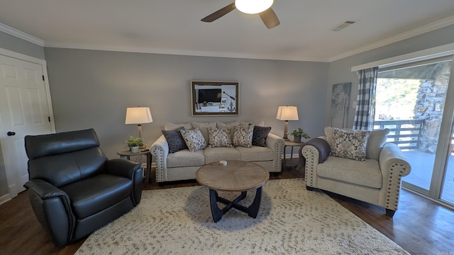 living area featuring ceiling fan, ornamental molding, wood finished floors, and visible vents