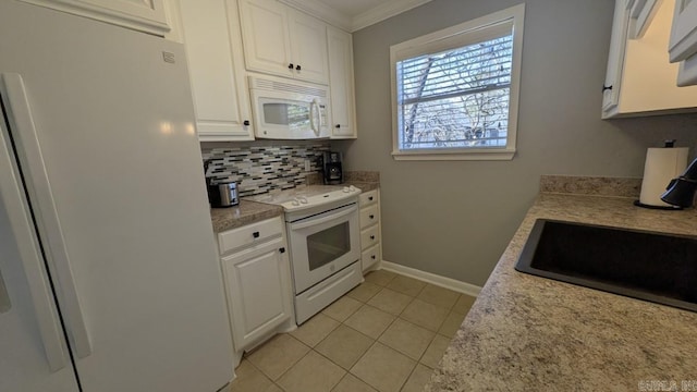 kitchen featuring tasteful backsplash, white appliances, light countertops, and white cabinetry