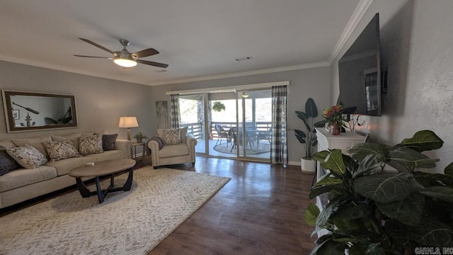 living room with baseboards, visible vents, ceiling fan, wood finished floors, and crown molding