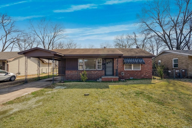 view of front facade featuring a front yard, concrete driveway, brick siding, and an attached carport