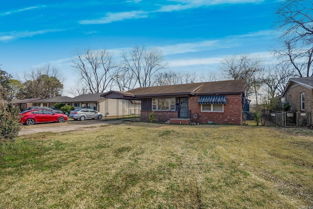 view of front facade featuring driveway, crawl space, fence, a front yard, and brick siding